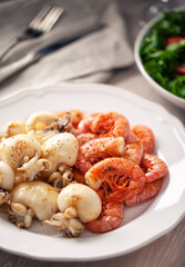 Grilled prawns and cuttlefish on a plate. High quality photo.