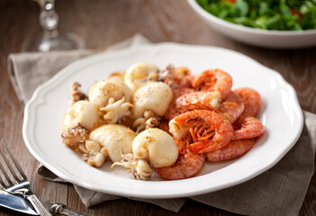 Grilled prawns and cuttlefish on a plate. High quality photo.