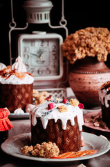 Easter cakes. Panettone. Traditional Easter cake with orange, candied fruit, raisins and cinnamon on a rustic background. Close-up