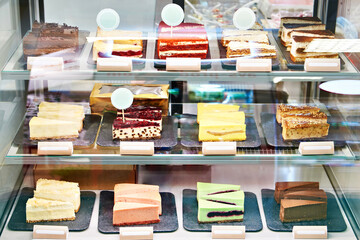 Assortment of cheesecakes on showcase in store