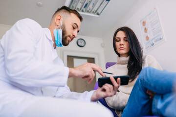 dentist showing teeth panoramic x-ray on phone. dentistry and he © Ivan