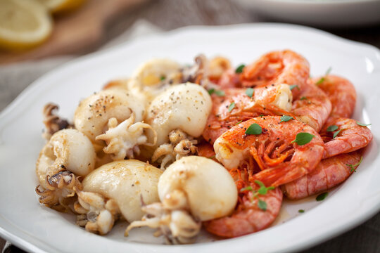 Grilled prawns and cuttlefish on a plate. High quality photo.