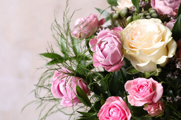 Fototapeta premium Beautiful bouquet with roses on beige background, closeup
