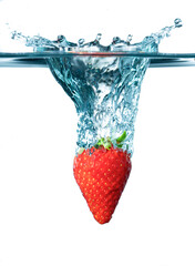 Strawberry falling in water. Splashing water