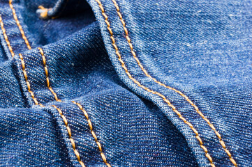 clothing items blue stonewashed faded jeans cotton fabric texture with seams, clasps, buttons and...