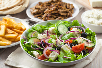 Greek Salad with Gyros and Fries. High quality photo.