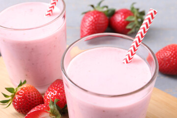 Delicious drink with strawberries on table, closeup