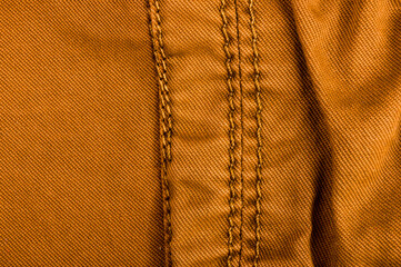clothing items stonewashed cotton fabric texture with seams, clasps, buttons and rivets, macro