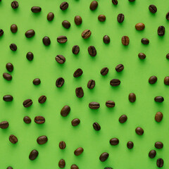 Patern of roasted coffee beans on green background,minimal compotision