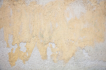 Old yellow painted wall background, partially faded