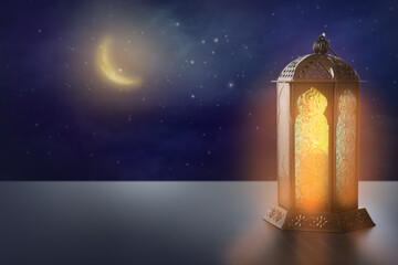 Beautiful decorative Arabic lantern on table at night, space for text. Fanous as Ramadan symbol
