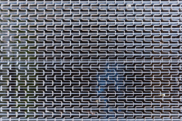 Close up of iron grid texture background silver metal pattern on the ground