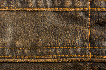 clothing items stonewashed cotton fabric texture with seams, clasps, buttons and rivets, macro
