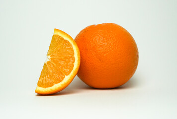 Citrus fruit and orange slice on white background.