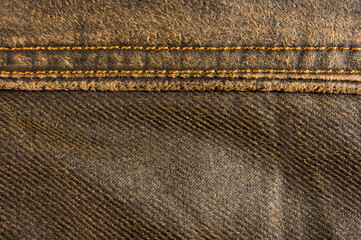 clothing items stonewashed cotton fabric texture with seams, clasps, buttons and rivets, macro