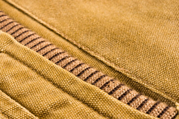 clothing items stonewashed cotton fabric texture with seams, clasps, buttons and rivets, macro