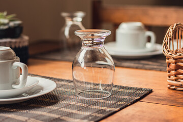 coffee cup and juice glass on a table