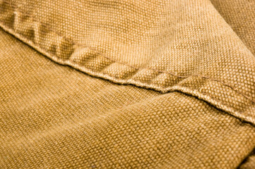 clothing items stonewashed cotton fabric texture with seams, clasps, buttons and rivets, macro
