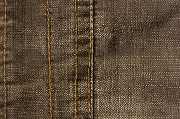 clothing items stonewashed cotton fabric texture with seams, clasps, buttons and rivets, macro