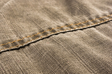 clothing items stonewashed cotton fabric texture with seams, clasps, buttons and rivets, macro