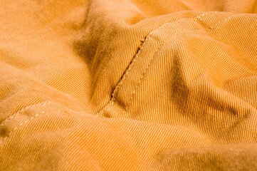 clothing items stonewashed cotton fabric texture with seams, clasps, buttons and rivets, macro
