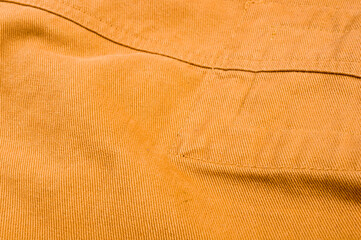 clothing items stonewashed cotton fabric texture with seams, clasps, buttons and rivets, macro