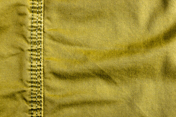 clothing items stonewashed cotton fabric texture with seams, clasps, buttons and rivets, macro