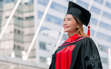 Asian beautiful long brown hair female student wearing graduation uniform with hat, looking away,...