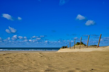 Fence in the beach close to the sea