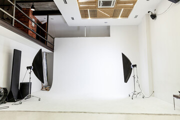 Empty photo studio with lighting equipment. Photographer workplace interior with professional tool...