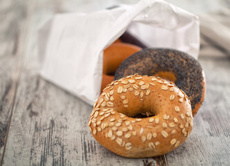 Mixed Fresh Bagels on a wooden table. High quality photo.