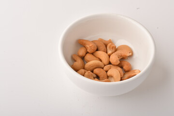 Heap of cashew nuts isolated on white background.