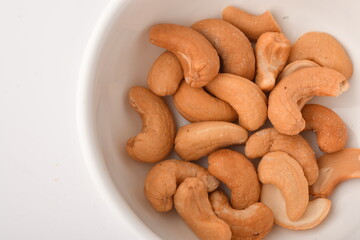 Heap of cashew nuts isolated on white background.