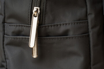 zipper on black material fabric. close-up of a snake fastener