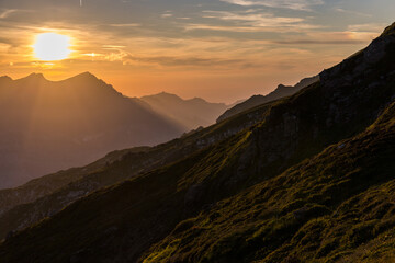 Naklejka premium Sunrise at the daybreak on the mountain area in Fessisseeli, Glarus, Switzerland