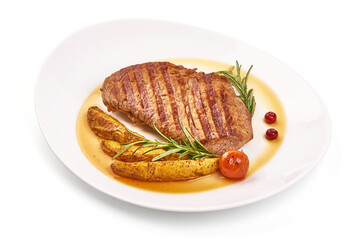Grilled beef steak with potato wedges, grilled pears, isolated on white background