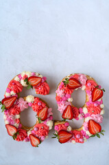 Birthday cake. Unusual modern design with strawberries. Spring time. Postcard for the holiday. Congratulations are bright and creative. Beautiful cake in the shape of number 69