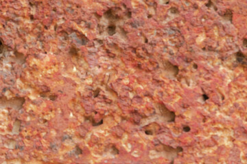blur of red laterite brick wall Porous and fine-grained Background pattern
