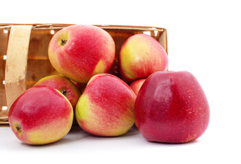 Apples fall out of the basket.