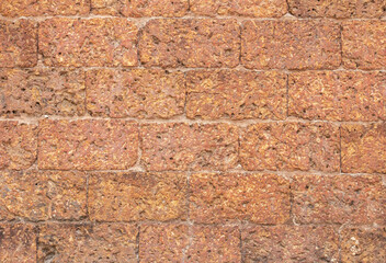 blur of red laterite brick wall Porous and fine-grained Background pattern