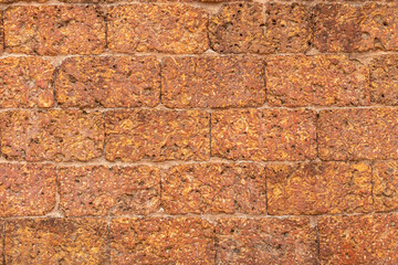 blur of red laterite brick wall Porous and fine-grained Background pattern