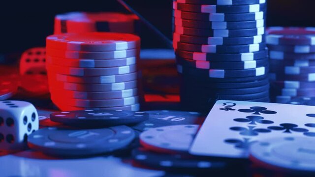 Casino chips and playing cards in motion. Concept of gambling or poker and entertainment. Close up macro shoot