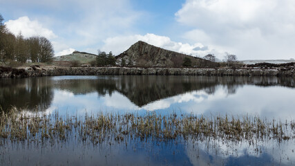 Winter landscape image of Cawfield Quarry and Crag on Hadrian's Wall. Roman Wall, in Northumberland, Engalnd, UK.