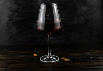 A glass of red wine and almonds