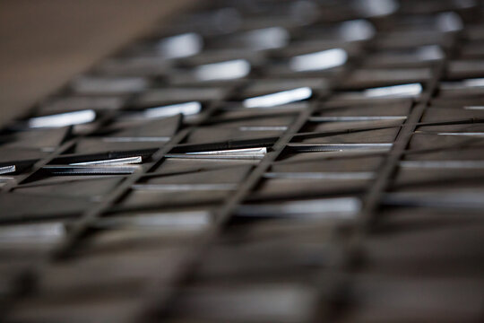 Uralsk, Kazakhstan: Sheet of steel after laser cutting CNC machine. Manufacturing of metal parts. Blurred photo, Low depth-of-field.