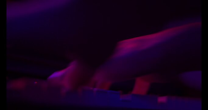 Close up of finger musician at the piano , The pianist playing  piano in the room ,classic piano,neon light,funny,hobby.