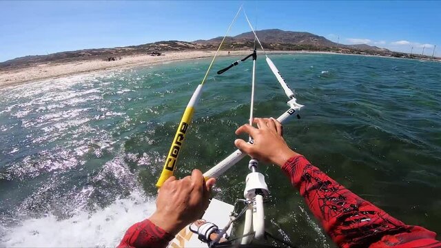 POV kitesurfing on sea waves carrying tons of trash from fish farms 