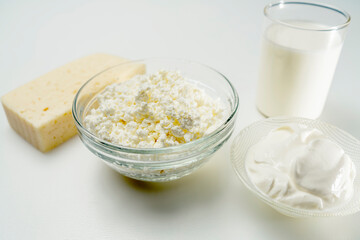 still life with dairy products cottage cheese, sour cream and yogurt on a white background