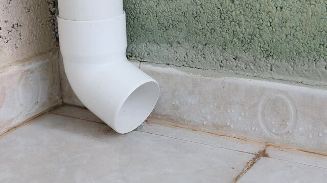 Water flowing from rain drain pipe