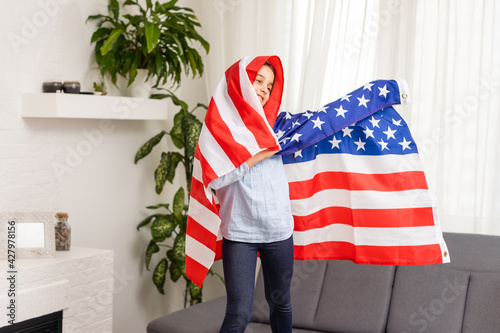 child holds a flag of America, USA.